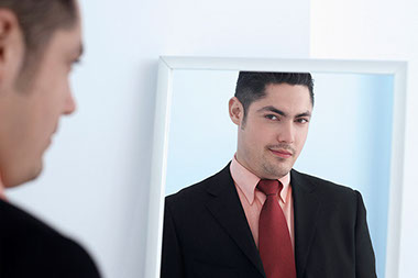 Image of man practicing speech in mirror.
