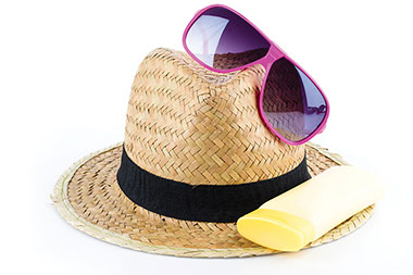 Image of sun hat, sunglasses and sunscreen.