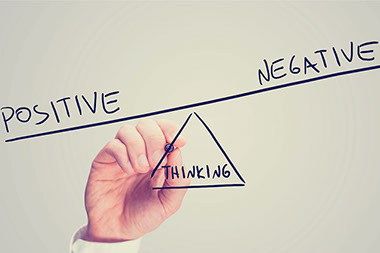 Image of a hand drawing 'Positive', 'Negative' and 'Thinking' as a seesaw.