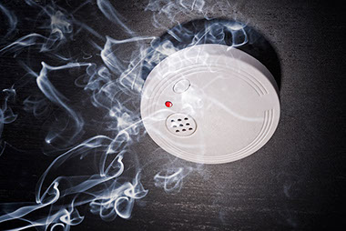 Image of smoke around a smoke detector.