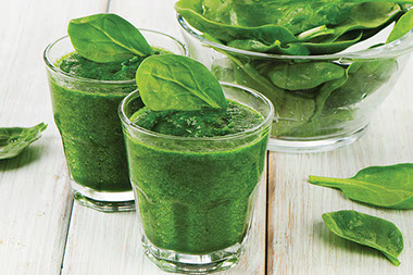 Two glasses of spinach smoothie.