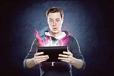 Screens and stress a close connection. Image of young man with colors popping out of his tablet.