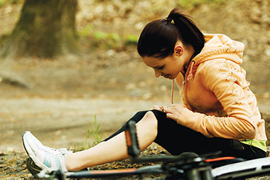 Image of women with knee injury from riding a bike.