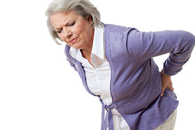 Image of older women holding her back in pain.