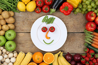 Image of smiley face made out of vegetables.