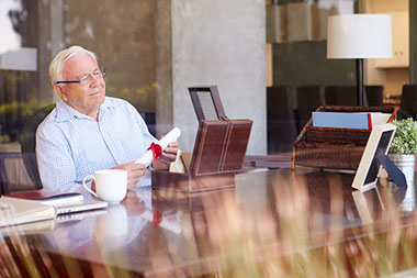 Image of older man sitting at desk.