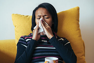 Image of young women in bed sick.