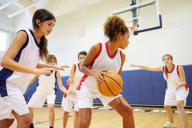 Image of high school girl's basketball team playing.