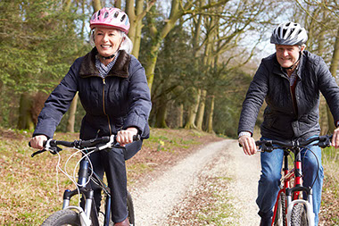 Older couple riding bikes.