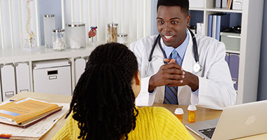 Image of doctor and patient talking.
