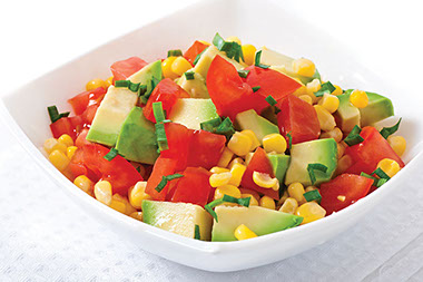 A bowl of avocado and corn salsa.