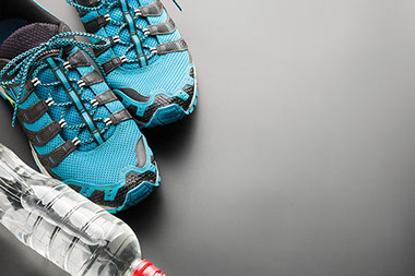 Image of athletic shoes and a bottle of water.