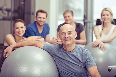 Image of a group of people with exercise balls.