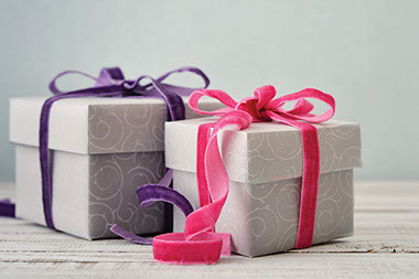 Tips for work-gift giving. Image of 2 wrapped gifts.