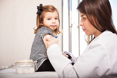 Image of toddler getting a shot by a doctor. Image of toddler getting a shot by a doctor.