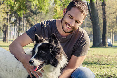 Man and dog outside.