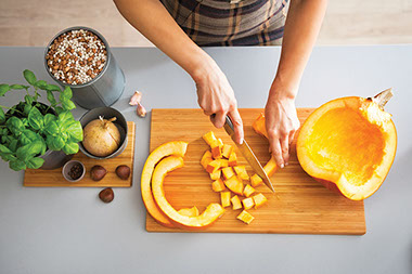 Bird-eyes view, cutting vegetable on a cutting board. Bird-eyes view, cutting vegetable on a cutting board.