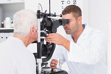 Simple steps to save your vision. Image of older male getting eyes checked by a doctor.