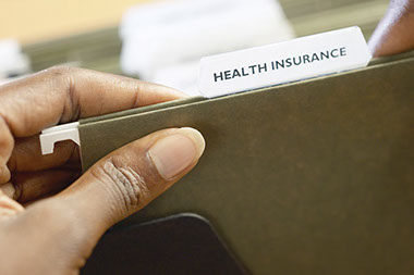 Image of a folder with the words "Health Insurance" in the tab.