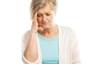 Image of older women with hand on head.