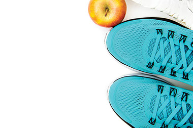 Pair of shoes with apple and water bottle.