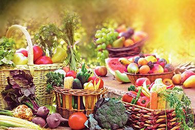 A variety of baskets filled with fruits and vegetables.