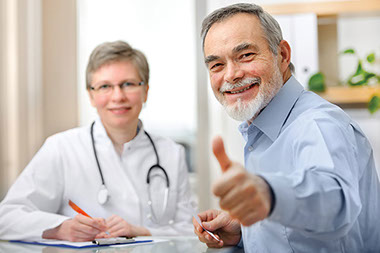 Image of doctor and patient with thumbs up.