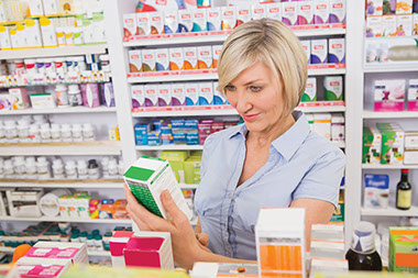 Image of women at store reading the medicine label.