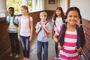 Image of school children with backpacks.
