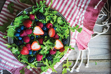 Image of salad filled with a variety of berries.