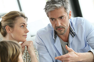 Image of parents talking to their child.