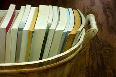 Image of bucket filled with books.