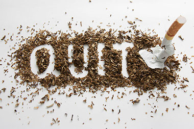Kick cigarettes out of your house. Image of the word "Quit" spelled within a pile of tobacco with a crused cigarette.