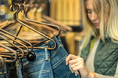 Image of women looking at jeans.