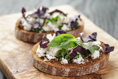 Rye sandwich with ricotta, herbs and basil.