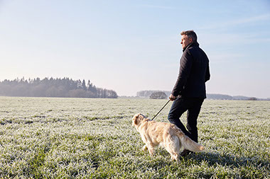 Image of man walking his dog.