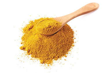 Curry powder and wooden spoon. Curry powder and wooden spoon.