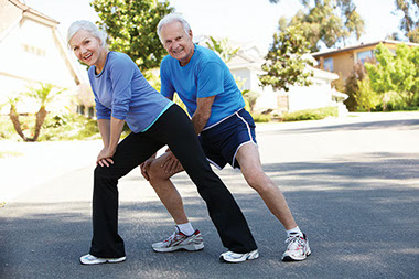 Senior couple streching before workout.