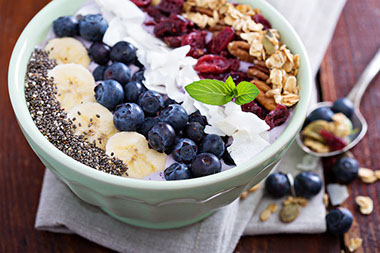 Breakfast smoothie bowl with fruits and granola.