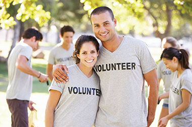 Helping others makes you happy. Image of volunteers smiling.