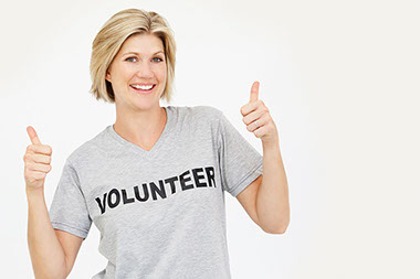 Meaning and purpose promote brain health. Image of female wearing a volunteer t-shirt.