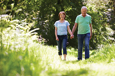 Image of couple walking through woods.