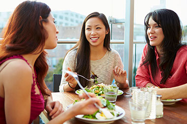 Three friends enjoying lunch at rooftop restaurant. Three friends enjoying lunch at rooftop restaurant.