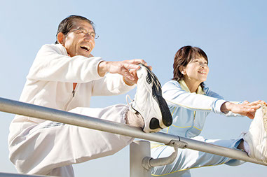 Image of an older Asian couple stretching.