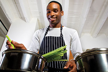 Image of man prepping food in the kitchen.