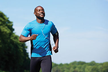 Image of man running while listening to music. Image of man running while listening to music.