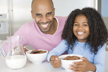 Image of father and daughter having breakfast.