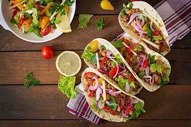 Mexican tacos with meat, beans and salsa.