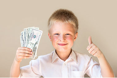Teaching kids to manage money. Image of boy holding money in one hand and thumbs up with the other hand.