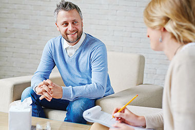 Image of man talking to a counselor.